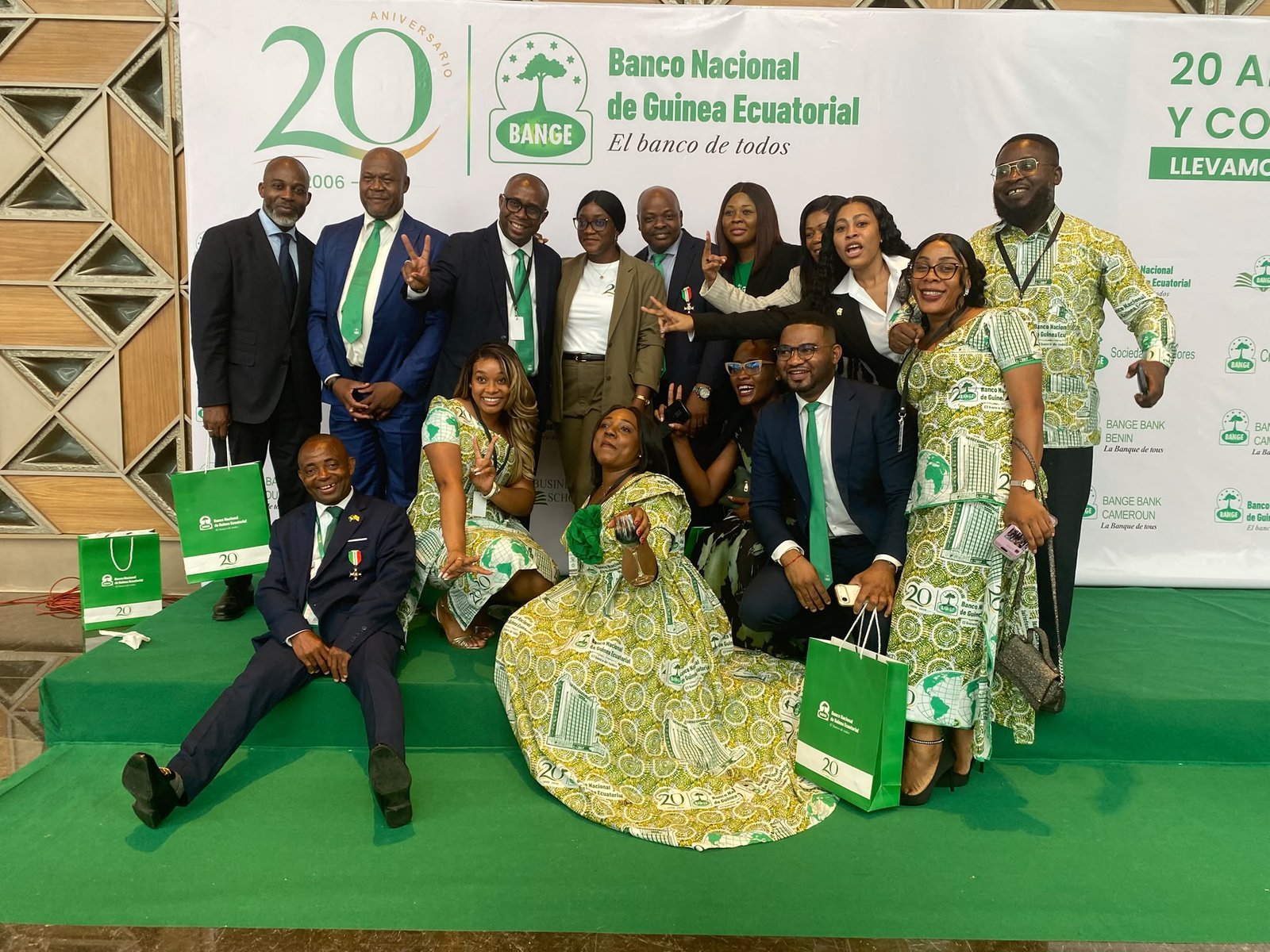 Un groupe de participants pose sur le tapis vert devant la toile de fond du 20e anniversaire de BANGE.